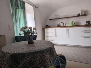 a kitchen with a table with a vase of flowers on it at Ferienwohnung im historischen Ortskern von Kallmünz in Kallmünz