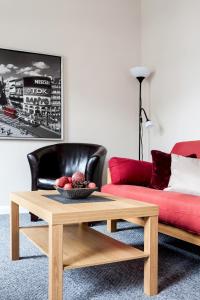 a living room with a coffee table and a red couch at Madison Hill - Bedford Hill 1 - One bedroom flat in London