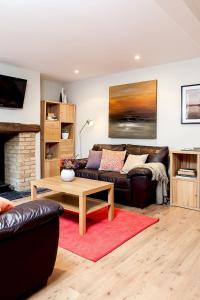 a living room with a couch and a coffee table at Madison Hill - Fernlea Garden 2 - One bedroom home in London