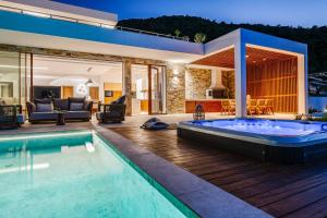 a house with a swimming pool and a living room at Alba Thesan in Marathias