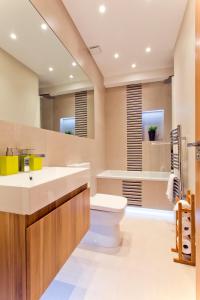 a bathroom with a toilet and a sink at Madison Hill - Byrne Garden 2 - One bedroom home in London