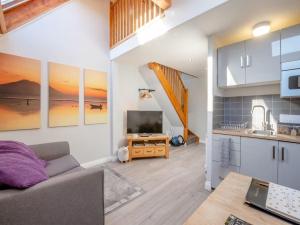a living room with a couch and a kitchen at Northlands Farm Superior Chalet 2 in Chichester