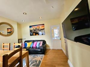 sala de estar con sofá de cuero negro y mesa en Splendid Stay By Sensational Stay Short Lets & Serviced Accommodation At Manor Street, en Belfast