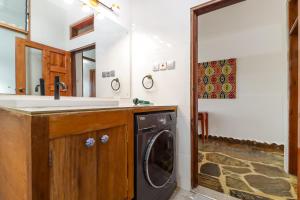 a bathroom with a sink and a washing machine at Westenfield One Bedroom Apartment, with Beach Access, Malindi in Malindi +16 photos