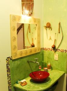 a bathroom with a red sink and a mirror at Pousada Esmeralda in Salvador