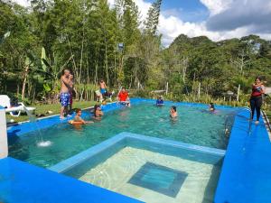 a group of people in a swimming pool at la hogareña in Calima