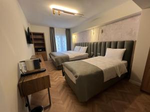 a hotel room with two beds and a television at Iris Han Hotel in Istanbul