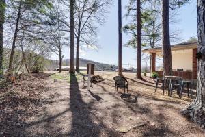 a house with a table and chairs in the woods at Peaceful Trenton Home with Patio Near Hiking! in Trenton