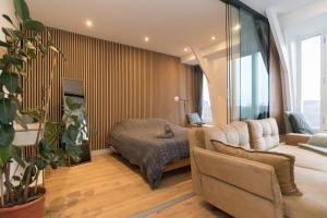 a living room with a bed and a couch at Canal view home in the center in Amsterdam