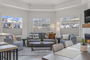a living room with couches and a fireplace at Mountain Vista Escape Downtown in Canmore