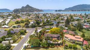 an aerial view of a suburb with a road and a town at Surf, Play and Stay in Tairua