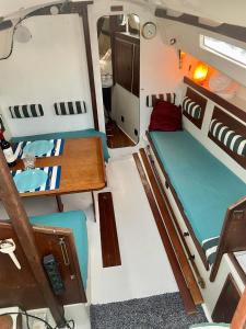 Cette petite chambre comprend un lit et une table. dans l'établissement Nuit insolite à bord d’un voilier, à La Rochelle