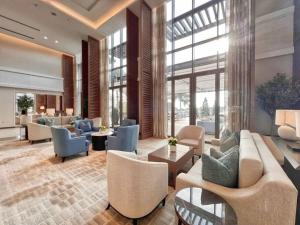 a lobby with couches and chairs in a building at Luxury the address 3BR in Fujairah
