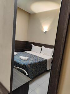 Postel nebo postele na pokoji v ubytování Hotel Romano
