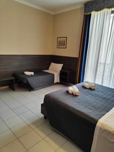 Postel nebo postele na pokoji v ubytování Hotel Romano