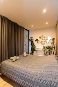 a bedroom with a large bed with pillows on it at Canal view home in the center in Amsterdam