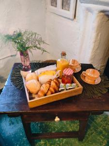 a tray of bread and pastries on a table at la casita del pueblo PET friendly granada in Acebuches