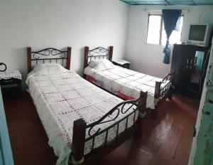 Postel nebo postele na pokoji v ubytování Hostal Perla Del Norte