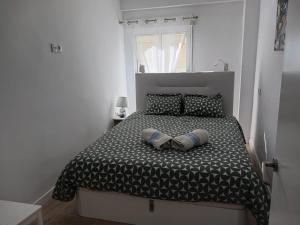 a bedroom with a bed with two pillows on it at A 50 m de la plage in Cullera