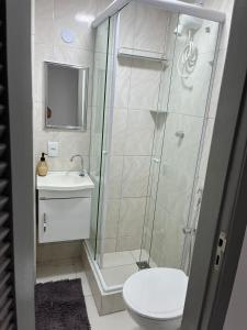 a bathroom with a shower and a toilet and a sink at Copacabana AP na esquina da praia in Rio de Janeiro