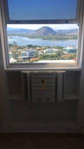 a window in a room with a view of a mountain at Apê na Barra vista incrível in Rio de Janeiro