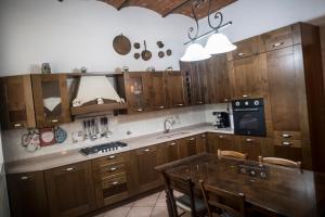 a kitchen with wooden cabinets and a glass table at Carla e Lui a Livorno in Livorno