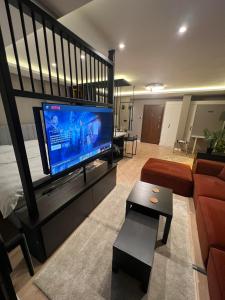 a living room with a large flat screen tv at Prive Living Suite in Istanbul