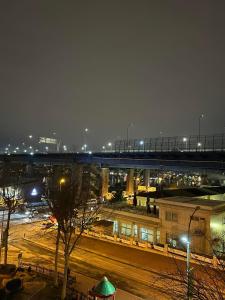 a bridge over a street with a city at night at Prive Living Suite in Istanbul