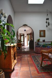 a hallway with a table and a chair in a room at Posada Santa Rita in Colonia del Sacramento
