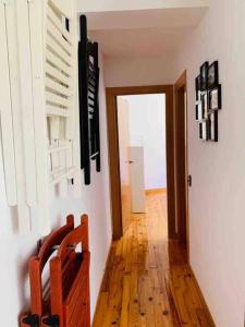 a hallway with a door to a room with wooden floors at Apartamento con encanto (Taüll) DEER 1 in Taüll