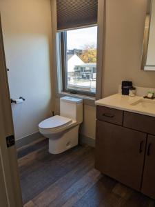 a bathroom with a toilet and a window at Modern State 209 Just Blocks Away From The Bay in Traverse City