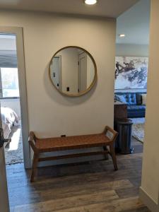 a mirror on a wall with a bench in a room at Modern State 209 Just Blocks Away From The Bay in Traverse City