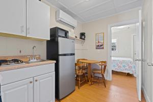 a kitchen with a refrigerator and a table in a room at Beach Motel and Suites in Old Orchard Beach