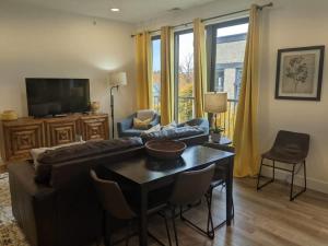 a living room with a couch and a table at Downtown Traverse City Capri Condo 316 in Traverse City