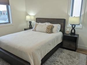 a bedroom with a bed with two lamps and a rug at Downtown Traverse City Capri Condo 316 in Traverse City