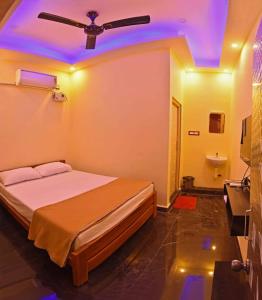1 dormitorio con 1 cama con techo azul en Sivakumar Paradise, en Mahabalipuram