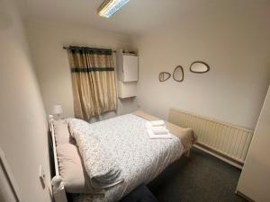 a small bedroom with a bed and a window at Stratford London Apartment in London