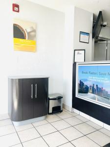 a waiting room with a counter and a tv at Motel 6-Santa Ana, CA in Santa Ana