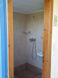 a bathroom with a shower with a shower head at Guesthouse Karidia in Skala Eresou