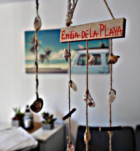 a sign that reads emilia dia plan hanging in a room at Emilia de la Playa in La Mata