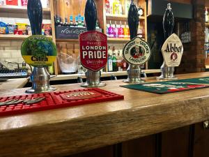 a counter in a bar with signs on it at The Bulls Head, Clipston in Clipston