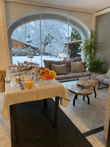 a living room with a table with oranges on it at B&B Casa il sasso in Pinzolo