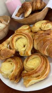 ein Teller mit Gebäck und Croissants auf dem Tisch in der Unterkunft Hostal La Vidala in Tafí del Valle