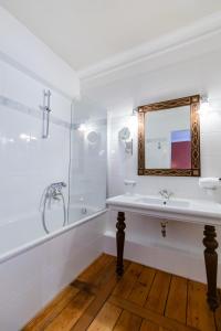 a white bathroom with a sink and a mirror at Schloss Neckarbischofsheim in Neckarbischofsheim