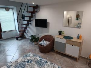 a living room with a staircase and a chair at Casetta Milù in Anacapri