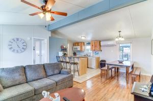 a living room and kitchen with a couch and a table at Monticello Home with Deck and Fire Pit Less Than 1 Mi to Water in Monticello