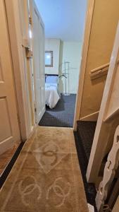 a hallway with a door leading to a bedroom at A Cosy Private Space- Free Wifi & Parking in Leeds