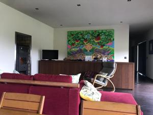 a living room with a couch and a painting on the wall at Casa Nova in Guimarães