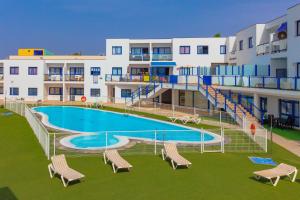 a swimming pool in front of a building at Astarita SUN in Costa Calma