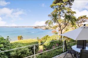 a view of the ocean from the balcony of a house at 180° Water View Apartment - Simply Amazing in Torquay